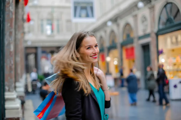 young happy woman holding shopping bags