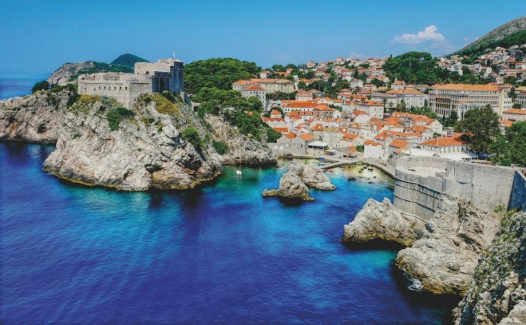 Dubrovnik's west harbour and city walls above deep blue water